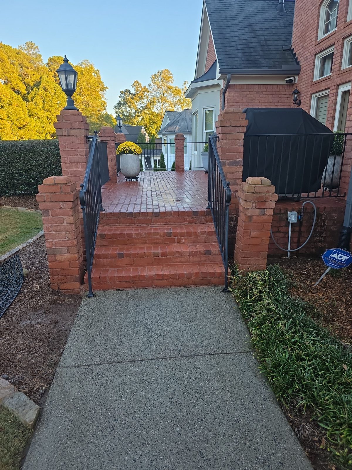 The same aggregate landing in Thornberry after cleaning, light exposed aggregate with a red brick step at the top of the frame
