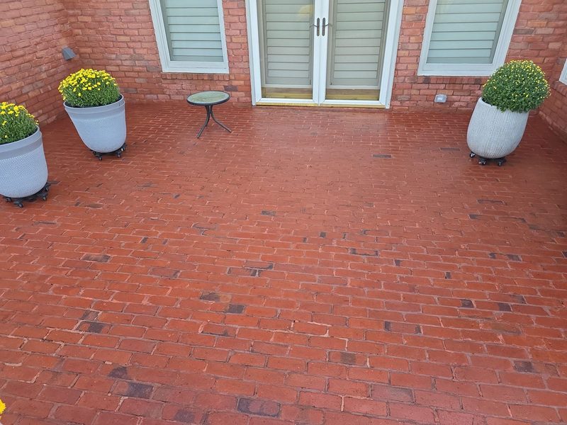 The same Thornberry Drive brick patio after cleaning, with the red brick visible again