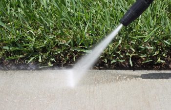 pressure cleaning being done to a sidewalk