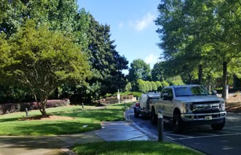 Alpharetta Pressure Washing truck with cleaning equipment parked on a driveway in a residential area