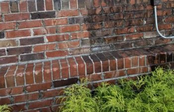 red-brick wall before and after pressure washing