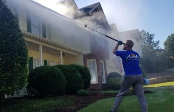 employee alpharetta pressure washing at work