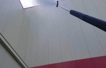 commercial building walls being pressure washed