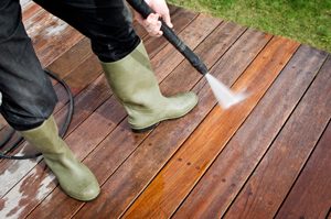 Person Pressure Washing a Wooden Deck Alpharetta GA